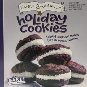 Colorful purple book cover with chocolate sandwich cookies and icing sugar